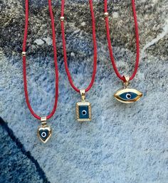 Hello, Welcome to my store ✨ If you have any questions, please contact me, i will be very happy to help you. You may want to take a look this important informations below ! ✨ 3 different shape of Blue Evil Eye 🧿Amulets with red string chain are for sale.  ✨ Pendants contain red string chain, it is 50cm (19,68inches) + 3cm adjustable chain. ✨ Gold plated, Suitable for double-sided use. ✨Mimimal collection materials are 925K good quality silver & natural gemstones & Glass Beads and very good quality rope.    ✨If you cannot find the size you are looking for, you can write to me even for your special orders; but please keep in mind; this may exceed the normal delivery time. ✨Parcels are delivered within max 2-7 days. If you need faster (1-4 days), please upgrade your shipping. Please keep in Blue Engraved Amulet Jewelry, Blue Engraved Amulet Style Jewelry, Red Sterling Silver Jewelry For Gift, Good Luck Amulet Jewelry With Round Pendant, Evil Eye Amulet Jewelry, Handmade Yellow Gold Charm Necklace For Good Luck, Handmade Yellow Gold Good Luck Charm Necklace, Blue Spiritual Locket Jewelry, Handmade Round Pendant Jewelry As Gift