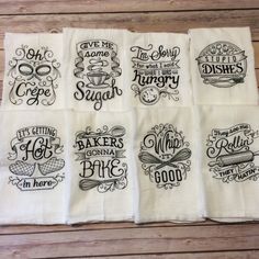 six flourcloths with different sayings on them sitting on a wooden table top