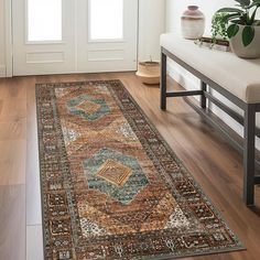 a large area rug in the middle of a room with a bench and potted plant