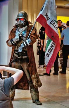 a man dressed as a soldier holding a flag