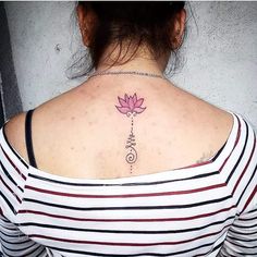 a woman with a pink flower tattoo on her back