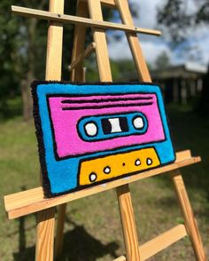 an old school cassette tape recorder hooked up to a easel