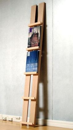 a wooden book shelf sitting on top of a hard wood floor next to a wall