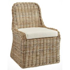 a wicker chair with a white cushion