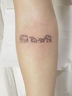 an elephant family tattoo on the arm