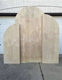 a large piece of wood sitting in front of a garage door