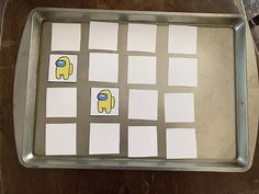 a metal tray with squares and pictures on it