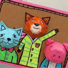 two paper mache cats and a fox on a card