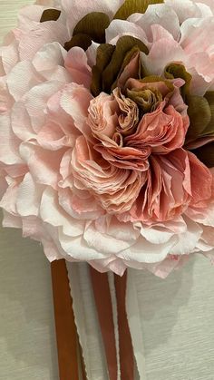 a bouquet of pink flowers sitting on top of a white wall