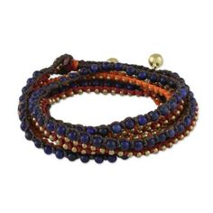 For a festive and delightfully bohemian addition to your wardrobe this necklace is designed and crafted by Thai artisan Tiraphan Hasub. She hand-braids red orange and brown lengths of polyester cord beaded with deep blue lapis lazuli and gleaming brass. The necklace closes with an adjustable button clasp accentuated by ringing brass bells. Adjustable Multicolor Artisan Wrap Bracelet, Bohemian Wrap Bracelet With Round Beads For Meditation, Adjustable Artisan Bracelets For Festivals, Artisan Adjustable Bracelets For Festivals, Multicolor Hand-strung Wrap Bracelet For Festival, Adjustable Hand Wrapped Bracelet For Festivals, Adjustable Hand Wrapped Wrap Bracelet For Festival, Festival Adjustable Hand Wrapped Bracelet, Beaded Wrap Bracelet For Festival