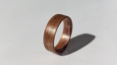 a wooden ring is shown on a white surface