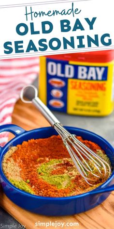 homemade old bay seasoning in a blue bowl with a whisk