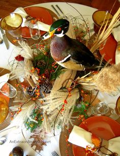 a bird sitting on top of a table surrounded by plates