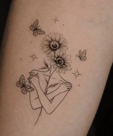 a woman with sunflowers and butterflies on her arm is shown in black ink