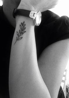 black and white photograph of a person with a tattoo on their arm