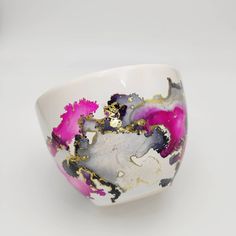 a white bowl with pink and black designs on it