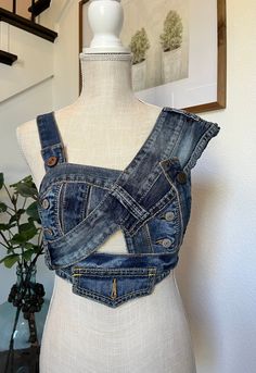 Whew!  After countless hours of hand sewing, I have completed this beauty!  If you're a lady that wears a size small 34B, this is the perfect top for you.  This futuristic, timeless denim top is perfect for your next concert/coachella/festival/girls night out etc.  This is definitely a fashion statement piece.  This is for the ladies who are not afraid to be a risk taker or don't mind standing out in a crowd.  The design of this top has 3D effect, made with several different denim jeans. The asymmetrical shoulder adds so much drama.  It goes perfectly with a pair of bare bottom jeans with height waistline or simply wear it with a ripped up  shorts with a pair of cowboy boots.   The possibility with this top is endless. Denim Bustier, Festival Girls, Denim Corset Top, Denim On Denim, Festival Concert, Denim Corset, Futuristic Fashion, Rock Chic, Embellished Jeans