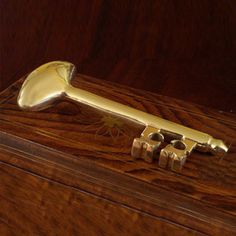 a golden metal object sitting on top of a wooden box