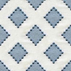 a blue and white diamond pattern on fabric