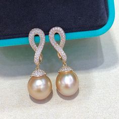 This South Sea pearl earring has carefully selected about 11mm South seawater gold pearls. Near round slightly flawed extremely strong light sterling silver earrings, finely crafted sterling silver accessories, luxurious inlays. The color is nice and the surface is translucent.Our Pearl Accessory Collection are all 100% Genuine pearls. We only source the best quality materials for our pearl accessories.Description:Materials: 925 Sterling Sliver plated with 18k GoldGemstone: Pearl、Cubic ZirconiaW Luxury Pearl Pendant Round Earrings, Luxury Round Pearl Pendant Earrings, Luxury Pearl Pendant Earrings, Exquisite Silver Earrings With High Luster, Luxury High Luster Sterling Silver Earrings, Exquisite High Luster Silver Earrings, Silver Akoya Pearl Earrings With High Luster, High Luster Silver Akoya Pearl Earrings, Yellow Gold Pearl Pendant Earrings In Sterling Silver