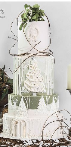 a three tiered cake decorated with white frosting