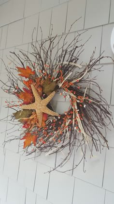 a starfish wreath is hanging on the wall