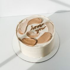 a white cake with frosting and some writing on it