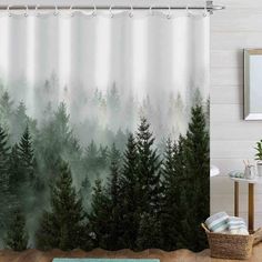 a shower curtain with trees in the forest on it's side and a blue rug next to it