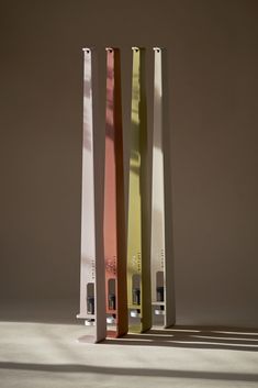 three tall metal poles with different colors on them