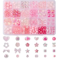 an assortment of pink and white beads in a plastic container with hearts, stars, bows, and more