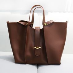 THE ABAGALE Tote | On Sale Now | Nichole Collection Leather Hand Bags For Women, Bag Lining, Bucket Tote Bag, Hand Bags For Women, Bucket Tote, Genuine Leather Totes, Leather Luggage, Branded Handbags, Storage Compartments