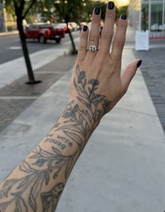 a woman's hand with a tattoo on it