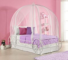 a pink and white bed with a canopy over it