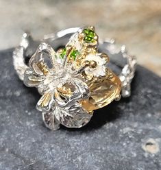 This is a one-of-a-kind, sterling silver ring. The stones are genuine citrine and chrome diopside. The front of the ring is 3/4 of an inch tall. It is new vintage - unworn old store stock.  The ring is plated with white and yellow gold, which means it will not tarnish. This retailed at $88. It comes in a tiny jewelry/gift box. Green Citrine Jewelry For Anniversary, Silver Multi-stone Citrine Rings, Silver Citrine Multi-stone Rings, Unique Sterling Silver Emerald Ring Collectible, Unique Collectible Sterling Silver Emerald Ring, Green Citrine Rings For Gifts, Unique Multi-stone Citrine Rings, Unique Citrine Birthstone Jewelry, Unique Citrine Ring With Polished Finish