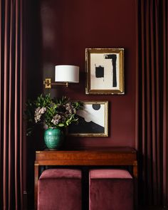 a living room with red walls and purple furniture