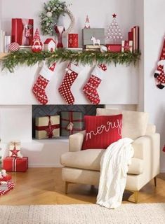 a living room decorated for christmas with red and white stockings on the fireplace mantel