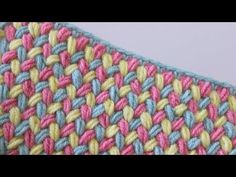 a close up view of the crochet stitchs on a knitted blanket