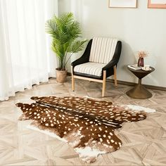 a living room area with a chair and deer hide rug on the floor next to a potted plant