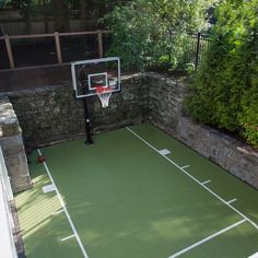 an outdoor basketball court in the backyard