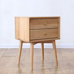 a small wooden table with two drawers on one side and an open drawer on the other