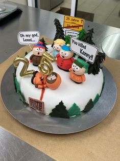 a birthday cake decorated with cartoon characters on top of a silver platter that says twenty five