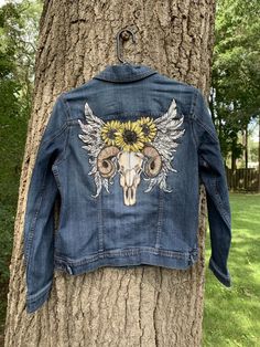 This is an upcycled denim jacket size medium ( see photos for measurements) Painted with professional quality paint and heat set for permanence with a boho tattoo design .. great for fall . If you don't see a design you like or need another size hop on over to my custom listing and message me Western Style Cotton Denim Jacket For Fall, Bohemian Dark Wash Denim Jacket For Fall, Bohemian Distressed Denim Outerwear, Bohemian Dark Wash Outerwear For Fall, Dark Wash Bohemian Outerwear For Fall, Hippie Cotton Denim Jacket For Fall, Bohemian Distressed Denim Jacket, Denim Blue Jacket For Fall Festival, Bohemian Fitted Denim Jacket For Fall