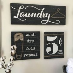 three wooden signs hanging on the wall above a toilet paper roll and towel dispenser