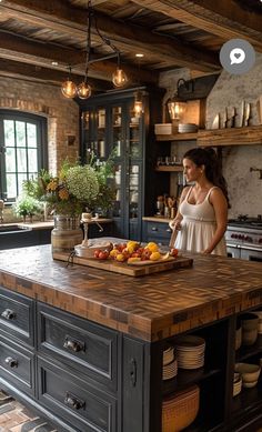 a woman standing in a kitchen next to a counter top with plates and bowls on it