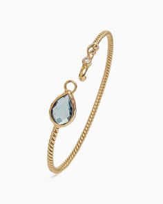 The Twisted Hook Bracelet boasts a distinctively timeless design, handcrafted in 14K solid gold and featuring a pear-shaped London blue topaz stone and a faceted round diamond. The twisted band and petroglyph add a unique touch to this sophisticated bracelet. Whether worn on its own for understated elegance or paired with a pair of Dewdrop Stone Earrings for a coordinated look, this pendant adds a touch of sophistication to any outfit. Metal: 14K solid gold Stone: London blue topaz, diamond Band Solid Gold Bracelet, Hook Bracelet, Blue Topaz Stone, Twisted Band, Gold Stone, Topaz Stone, Understated Elegance, Blue Gemstones, Diamond Band