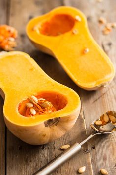 butternut squash with seeds and spoon on wooden table