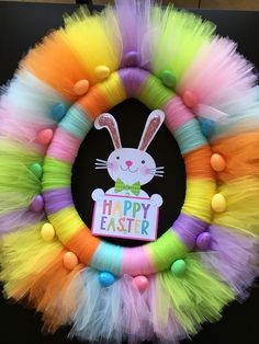 a colorful wreath with an easter bunny on it