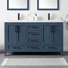 a bathroom with two sinks and mirrors on the wall next to a rug in front of it