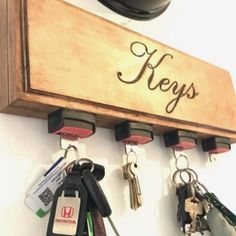 keys are hanging on a key holder that is attached to a wall