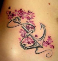 a woman's stomach with flowers on it and the letter e in the middle